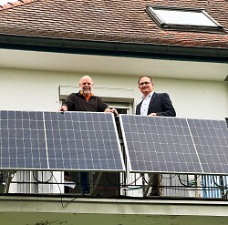 Auf dem Bild ist zu sehen wie der Erster Bürgermeister Wolfgang Steidle (re.) und der Hausbesitzer Wolfgang Merthan das Balkonkraftwerk begutachten